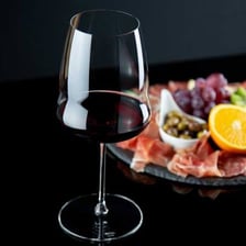 A glass of dark red Shiraz wine.