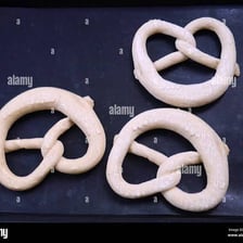 A baked pretzel formed into a looped knot shape.