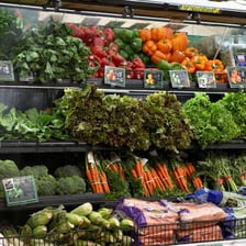 Fresh produce being lightly sprayed with water.
