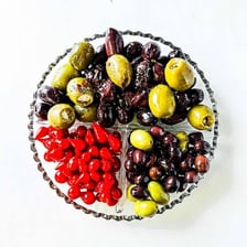 Green and black olives arranged on a relish tray