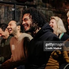 An audience laughing during a comic performance.
