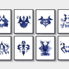 A set of symmetrical Rorschach inkblot test cards.
