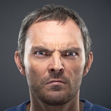 A person displaying an angry facial expression