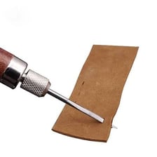 Pointed leatherworking awls beside a belt