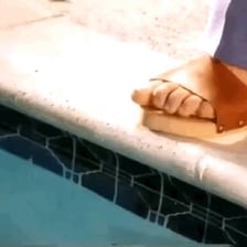 A person testing bathwater with a toe