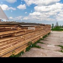 Cut wooden boards stacked at a lumber yard.