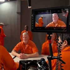 An actor performing directly toward a camera on a film set