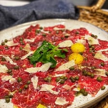 A plate of thinly sliced beef carpaccio