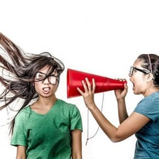 An angry person forcefully delivering a verbal rant.