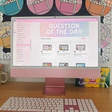 An Apple iMac desktop computer positioned on a classroom teacher’s desk.