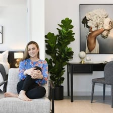 A person placing decorative objects around a room.