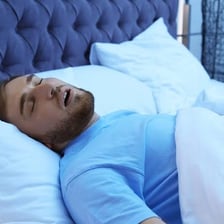 A person asleep in bed.