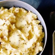 A small lump sits in a serving of mashed potatoes.