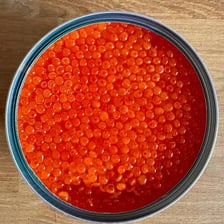 Fish roe displayed as small eggs beside caviar