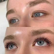 A beauty professional applying an eyelash tint
