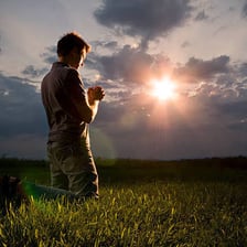 A person kneeling in prayer.