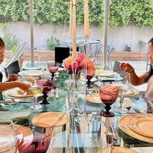 Children demonstrating polite behavior at a dinner table