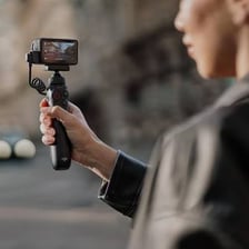 A content creator filming a video with a camera