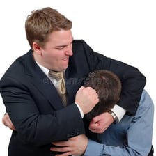 A person playfully rubbing a knuckle on a friend's head.