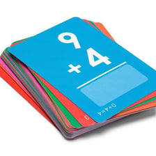 A student practicing memorization with a stack of flashcards.