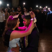 A couple dressed formally at a high school prom