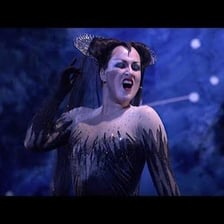 An opera singer performing a solo on stage.