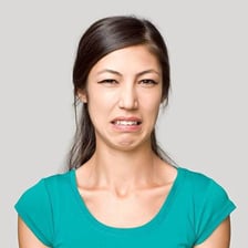 A person making a facial expression of disgust.