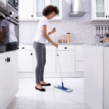 A mop being used to clean a floor