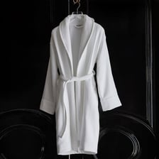 White robes hanging in a spa setting.
