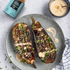 Charred grilled eggplant served with tahini sauce