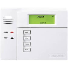 A home security keypad displaying an armed status.