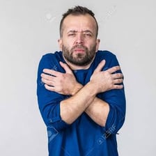 A person wearing a stern, emotionless facial expression