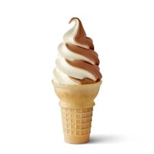 A cone topped with a spiral swirl of soft-serve ice cream.