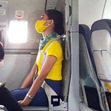 Passengers sitting in their seats inside an airplane before takeoff.