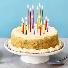 A birthday cake topped with lit candles.
