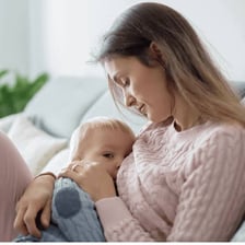 A parent feeding a baby during the weaning process