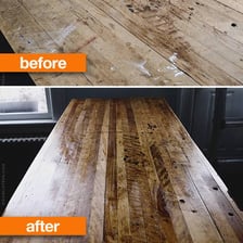 A worn wooden table being given a fresh finish.
