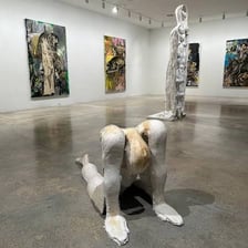 A visitor viewing abstract art in a modern gallery