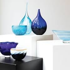 A studio displaying handmade pottery and blown-glass artwork.