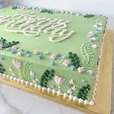 A rectangular birthday sheet cake covered with frosting.