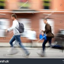 A person moving quickly through a city street