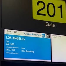 Airport flight information display showing estimated departure times