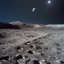 A view of the Moon showing its cratered lunar surface.