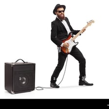 An electric guitar connected to an amplifier.