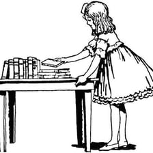 A person laying a book down on a table.