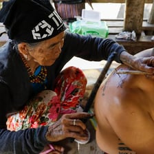 Whang-od applying a traditional Kalinga tattoo