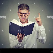A studious person reading books at a desk