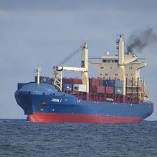 A large freighter ship traveling at sea.