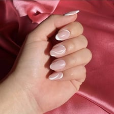 Fingernails with a classic French manicure and white tips