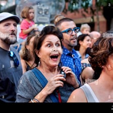 An audience reacting with amazement to a performance.